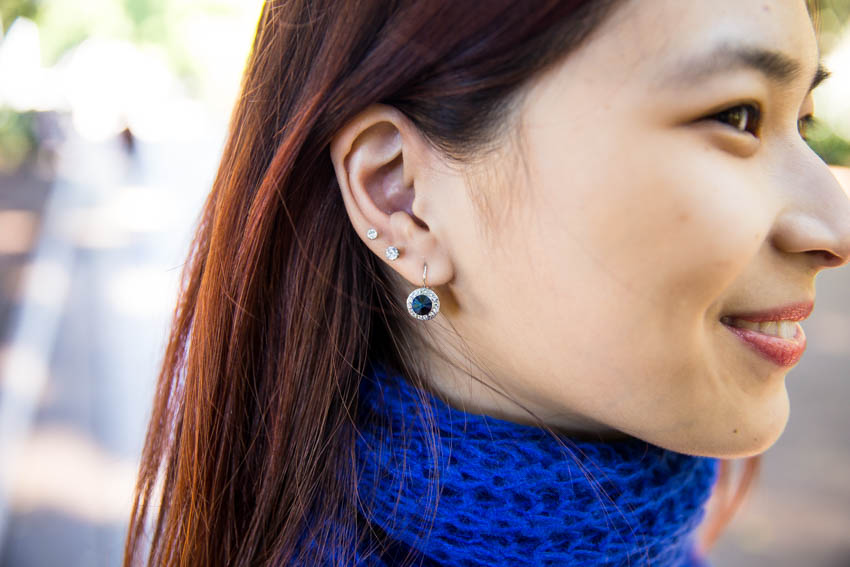 Close up of my ears with round blue drop earrings and