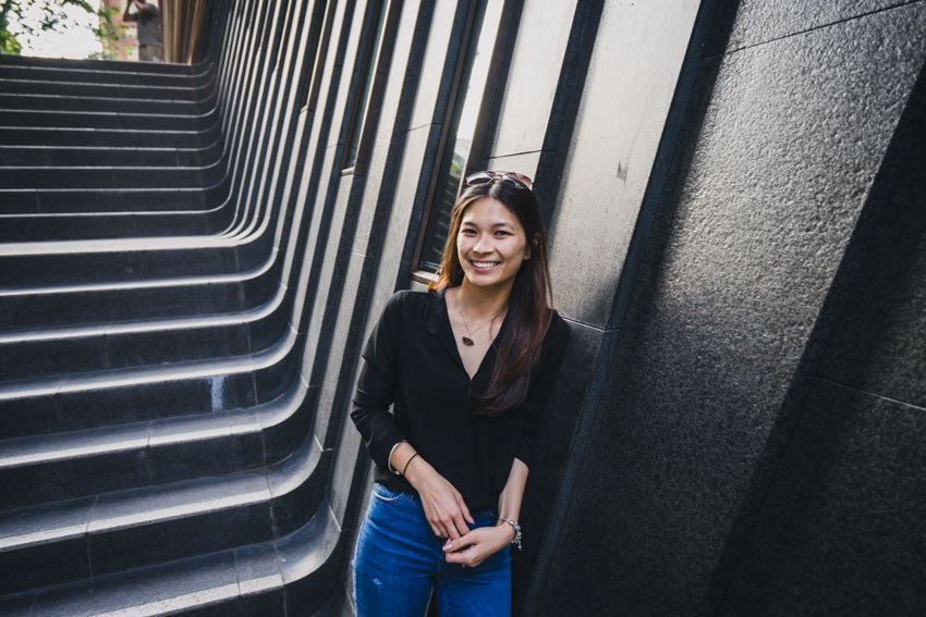 Close up shot of me smiling by the EY building steps