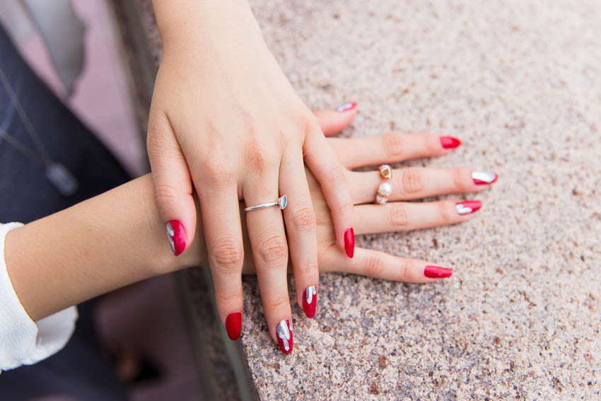 Close up of my red painted nails with silver crystal-printed nail wraps