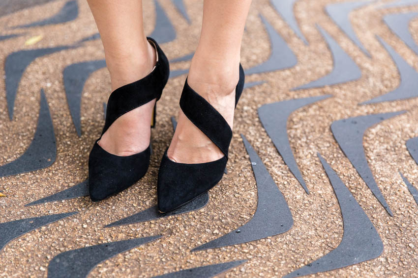 Close up of my pointed heels, standing on a boomerang-printed path