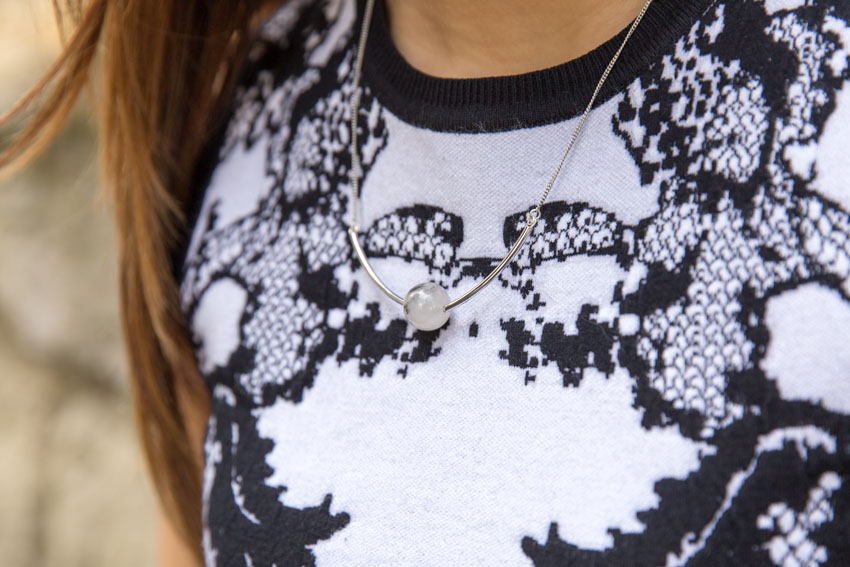 Close up of quartz necklace with curved edges