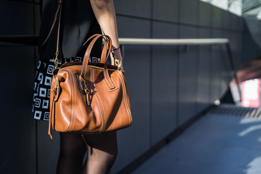 Close shot of my brown bag hung from my shoulder and sitting at my hip