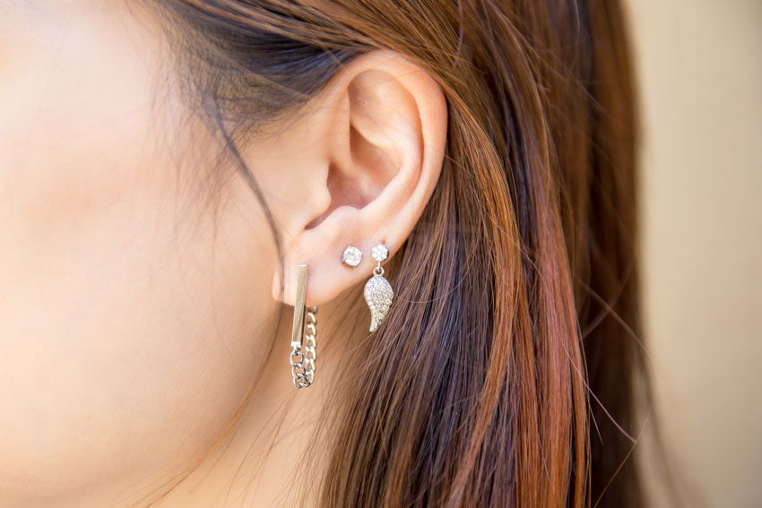 Close up of my left ear with wing earring, stud and bar earring.