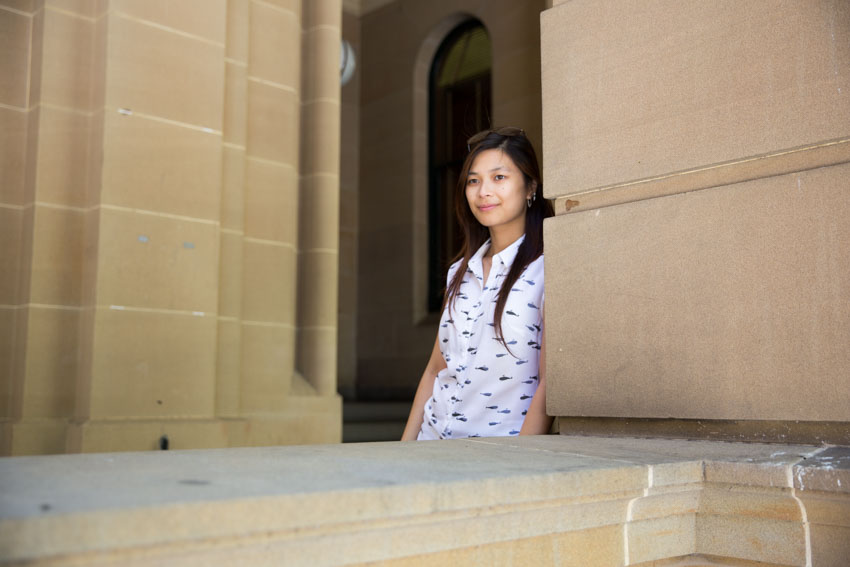 Me leaning against a stone pillar.