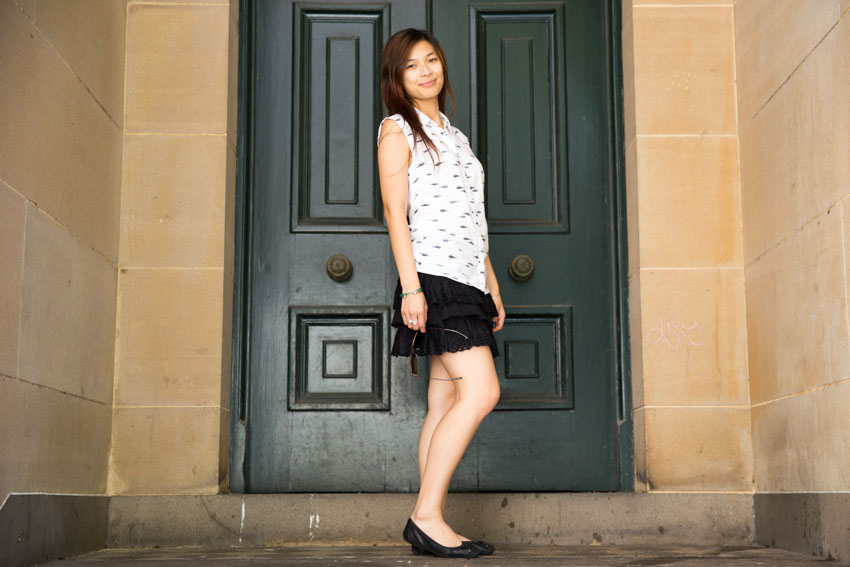 A full shot of me standing in front of an old green door.