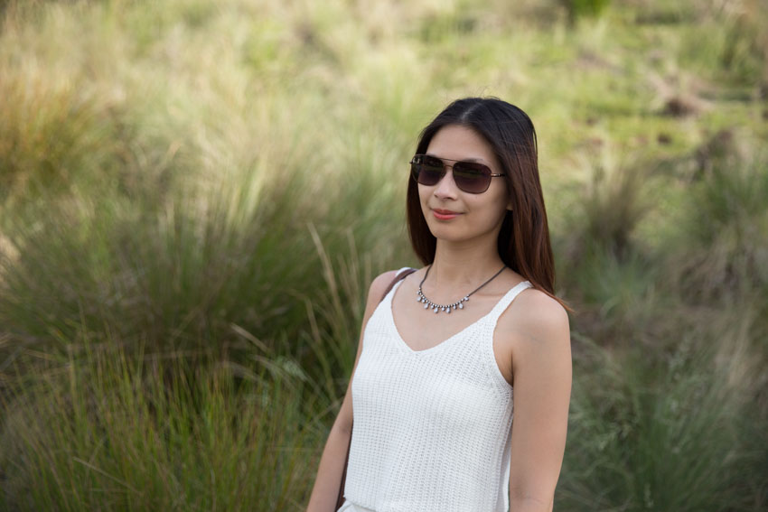 Me with my sunglasses on aganist a grassy backdrop