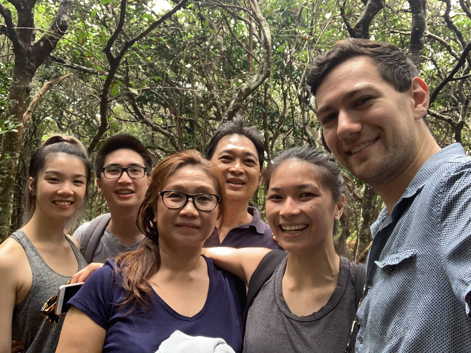 A photo of six people smiling, but also looking tired