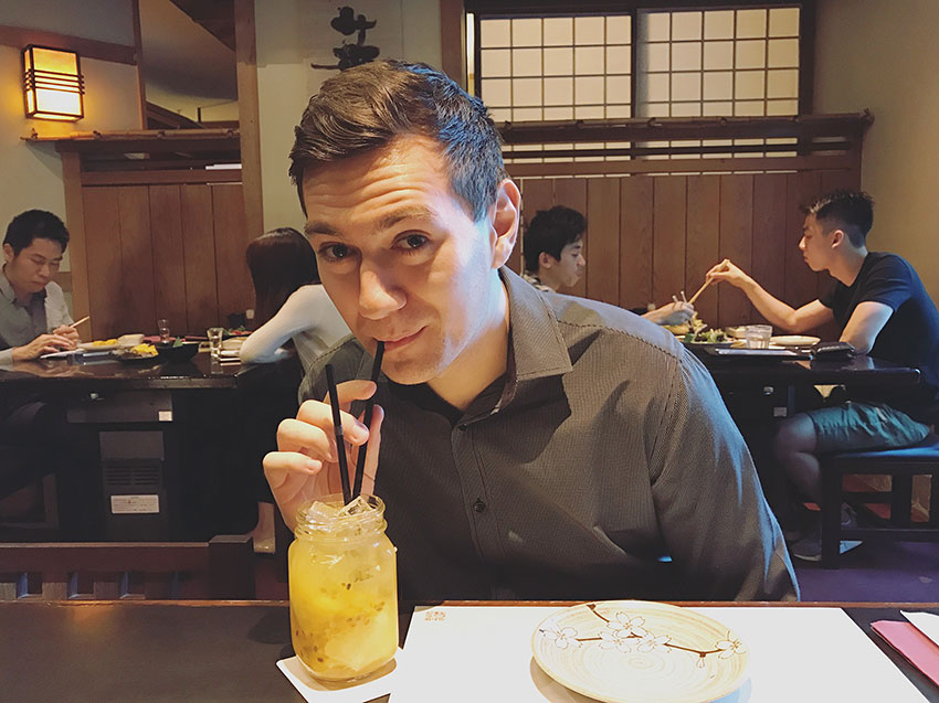 Nick drinking a cocktail