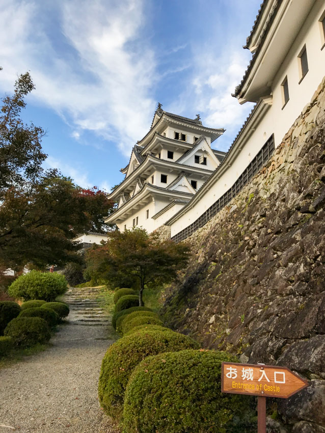 Gujo-Hachiman castle from the landing at the top of the mountain, near a sign pointing out the direction to entrance of the castle