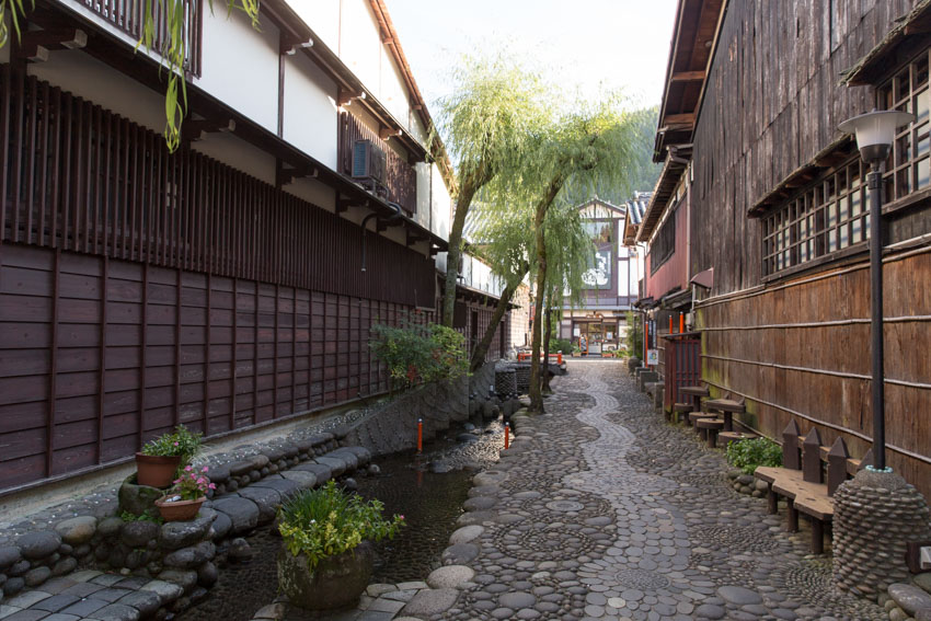 A stone/pebbled path with water canals