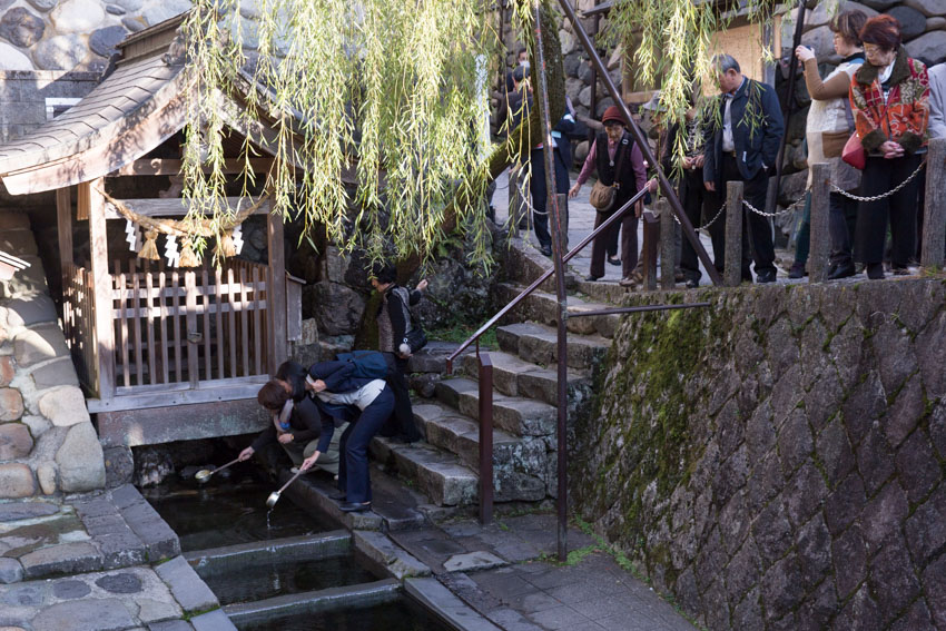People paying respects at the Sogi Sui water shrine