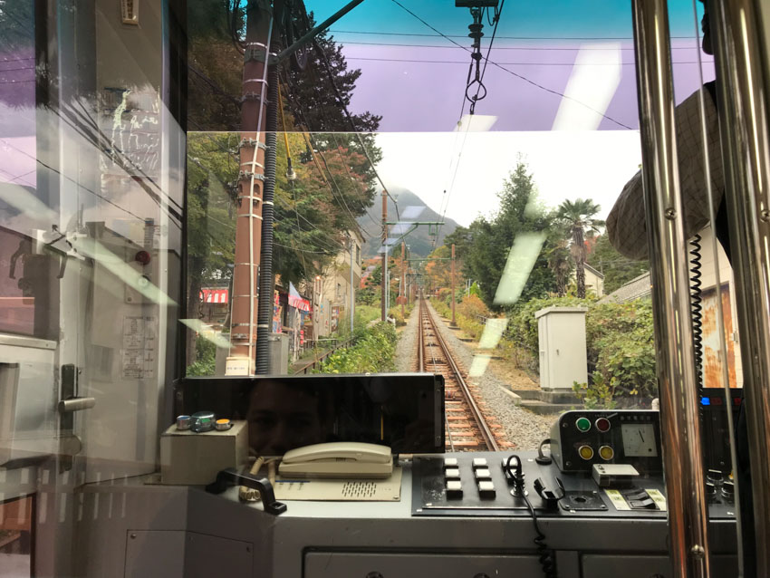 A view of train tracks from inside the train