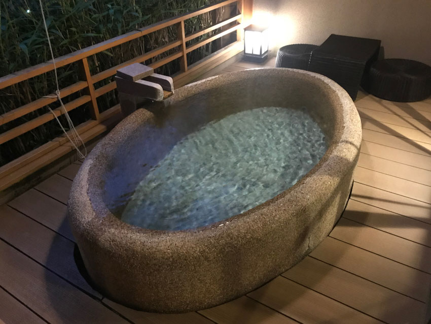 Our private onsen, an oval stone bath filled with water from the springs, which continually ran out of a tap
