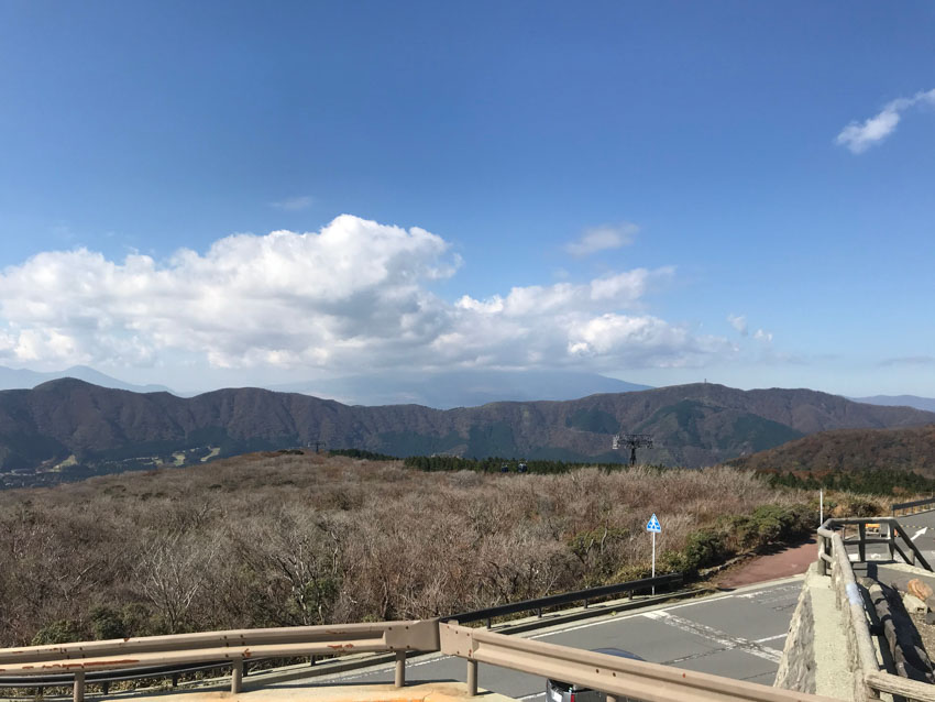 Mount Fuji in the distance, its peak covered in white clouds