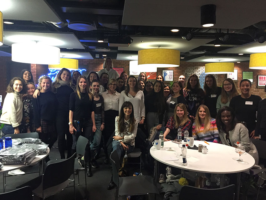 Amy surrounded by girls from the Code First: Girls program