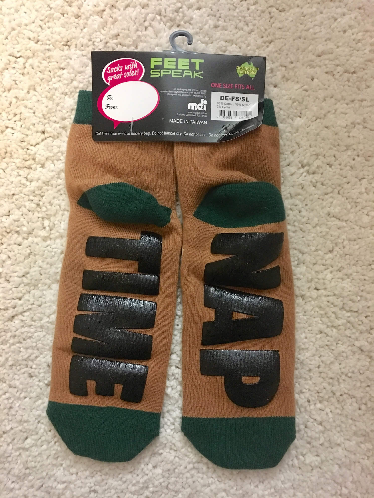 The bottom of two brown socks. One reads “NAP” and the other reads “TIME”