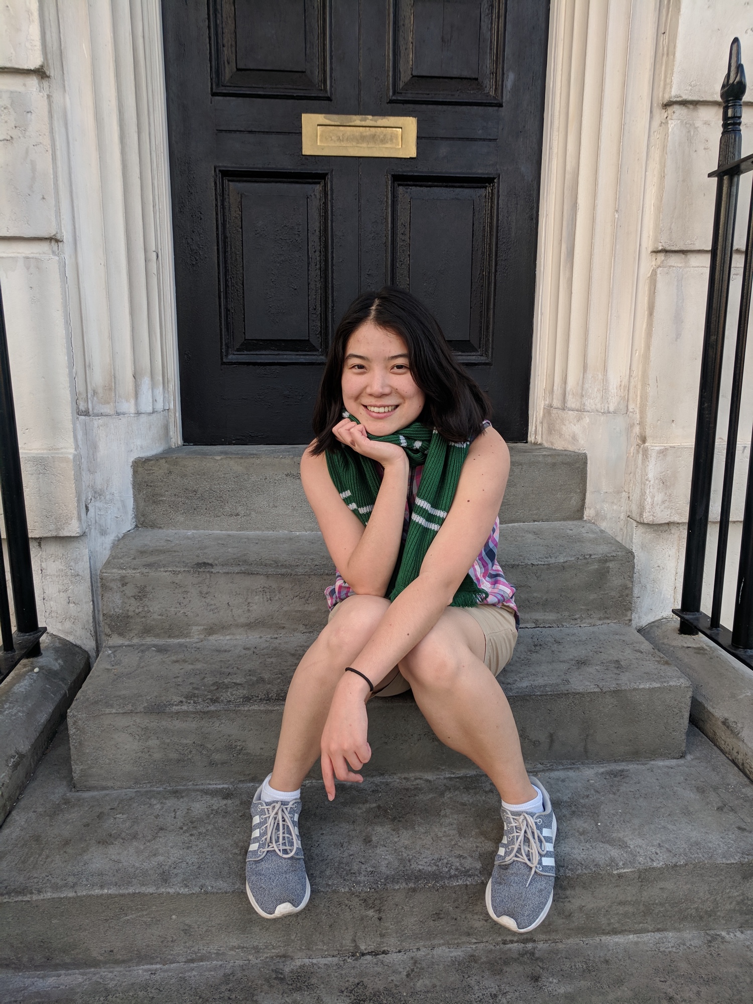 A woman sitting on the steps in front of a door