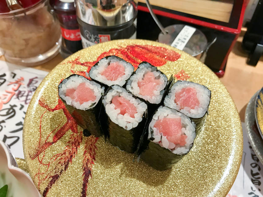 Six baby/mini (raw) tuna rolls on a plate