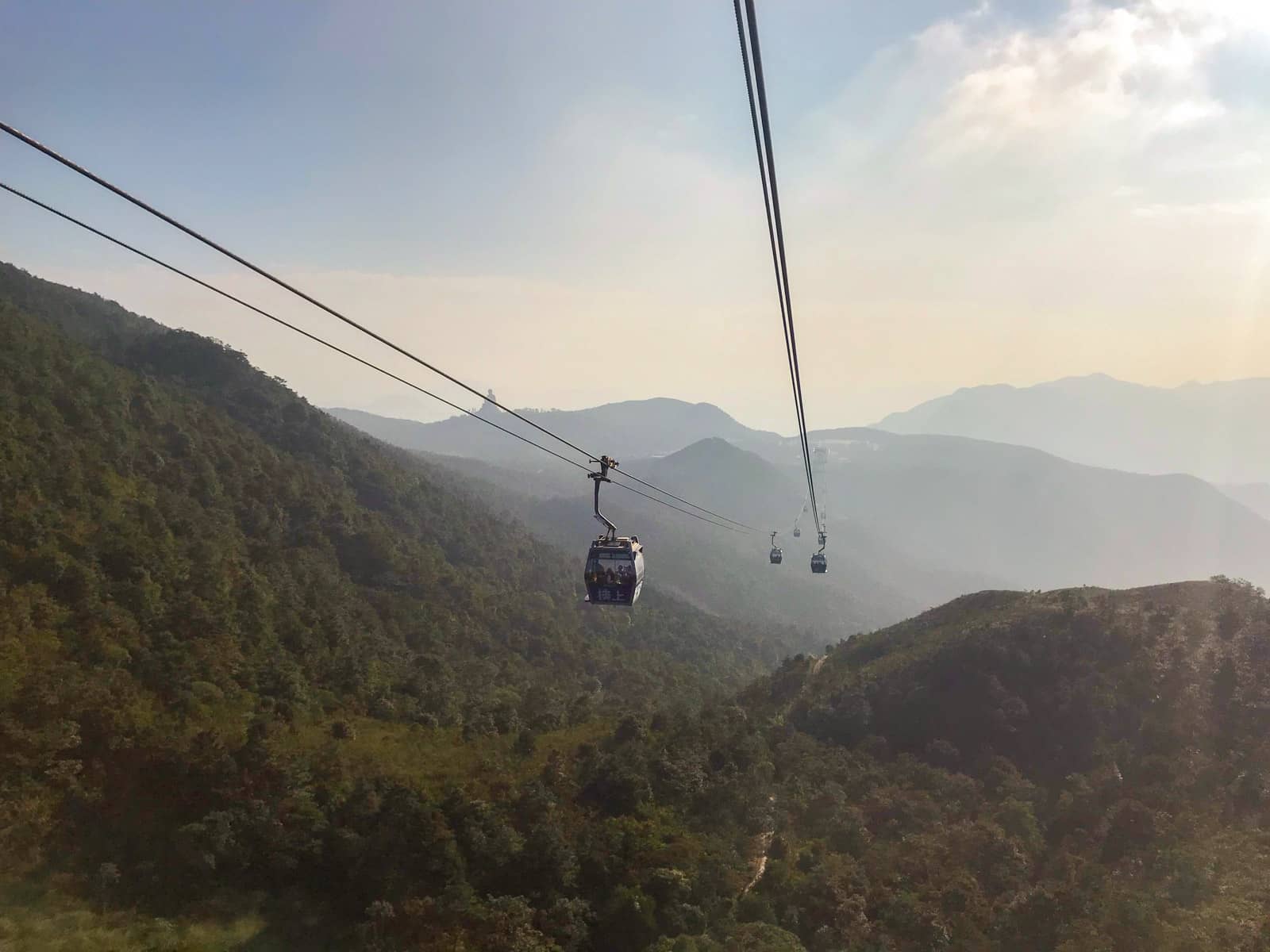 A view of two lines of cable cars going in opposite directions as seen from another cable car on the route