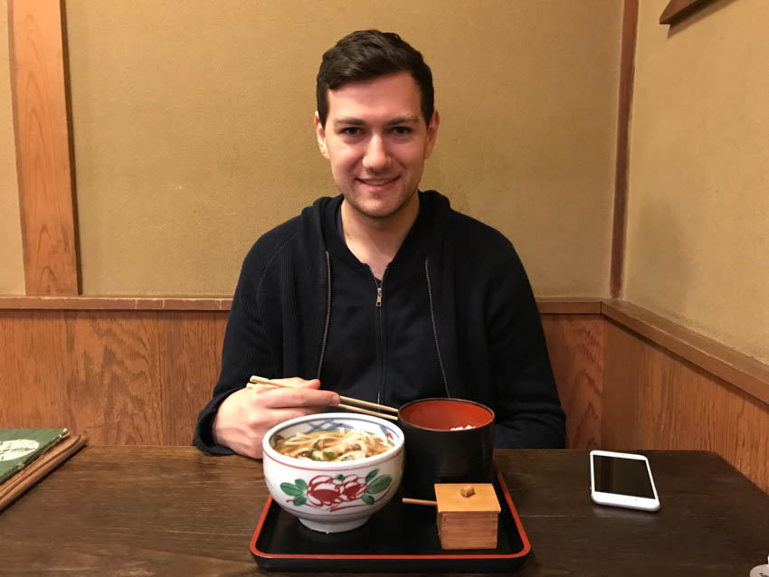 Nick sitting at a traditional Japanese table setting with his udon for lunch