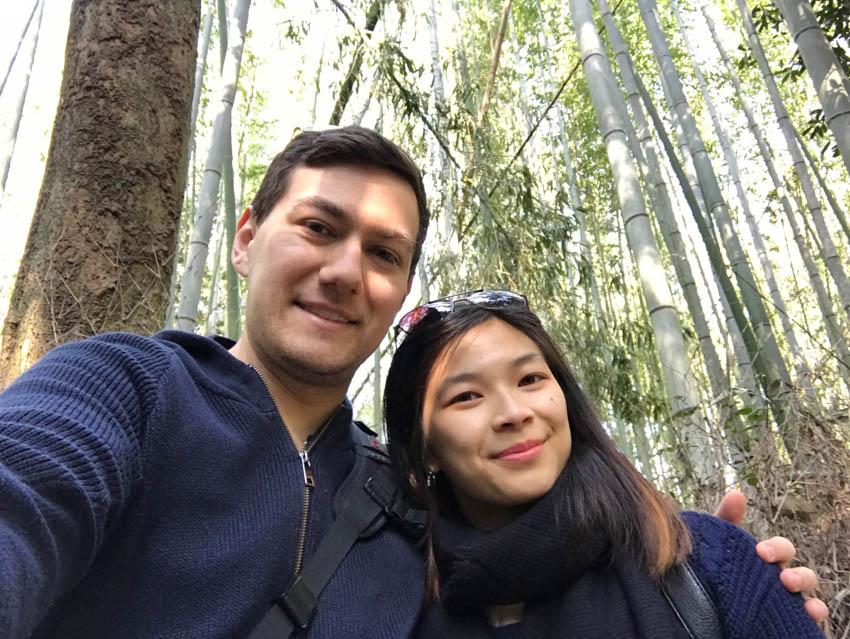 A selfie of myself and Nick with the Arashiyama bamboo rainforest behind us