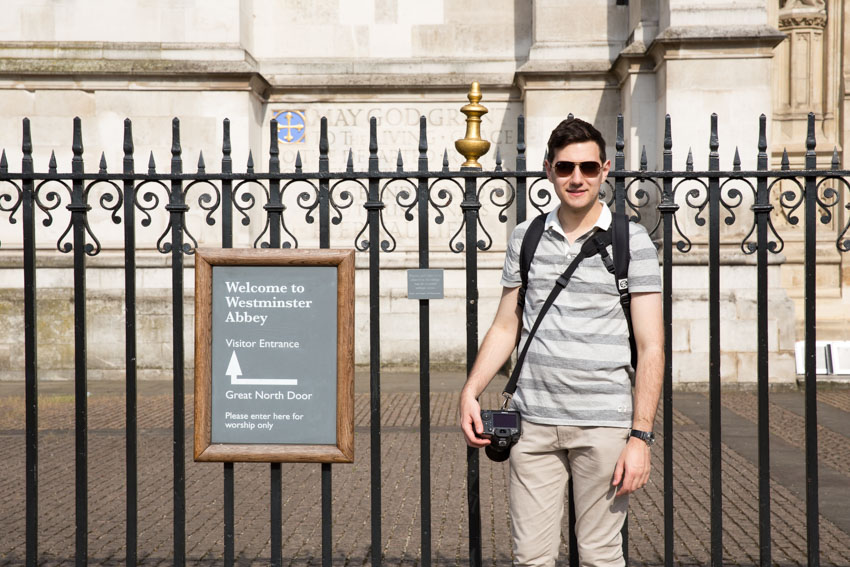 Nick standing in front of a gate with a Westminster Abbey sign