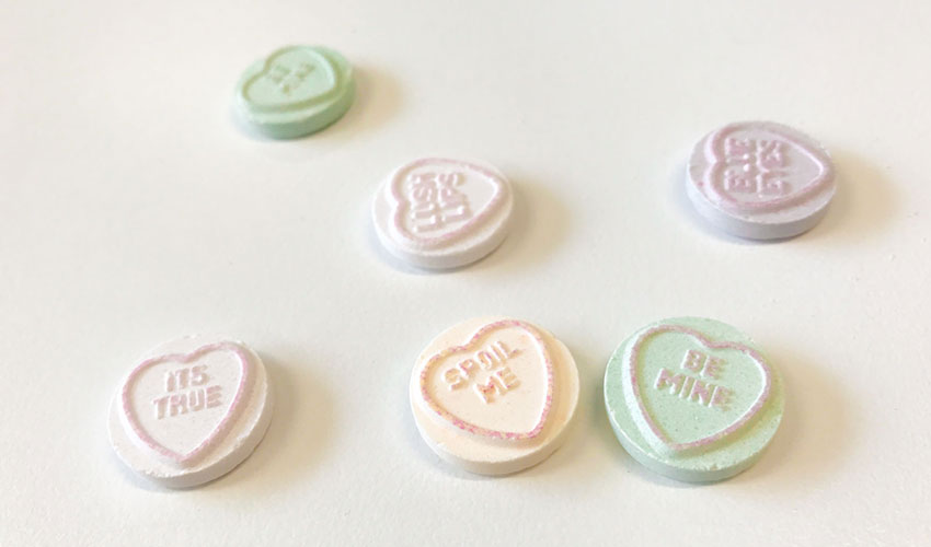 Candy hearts with love messages printed on them