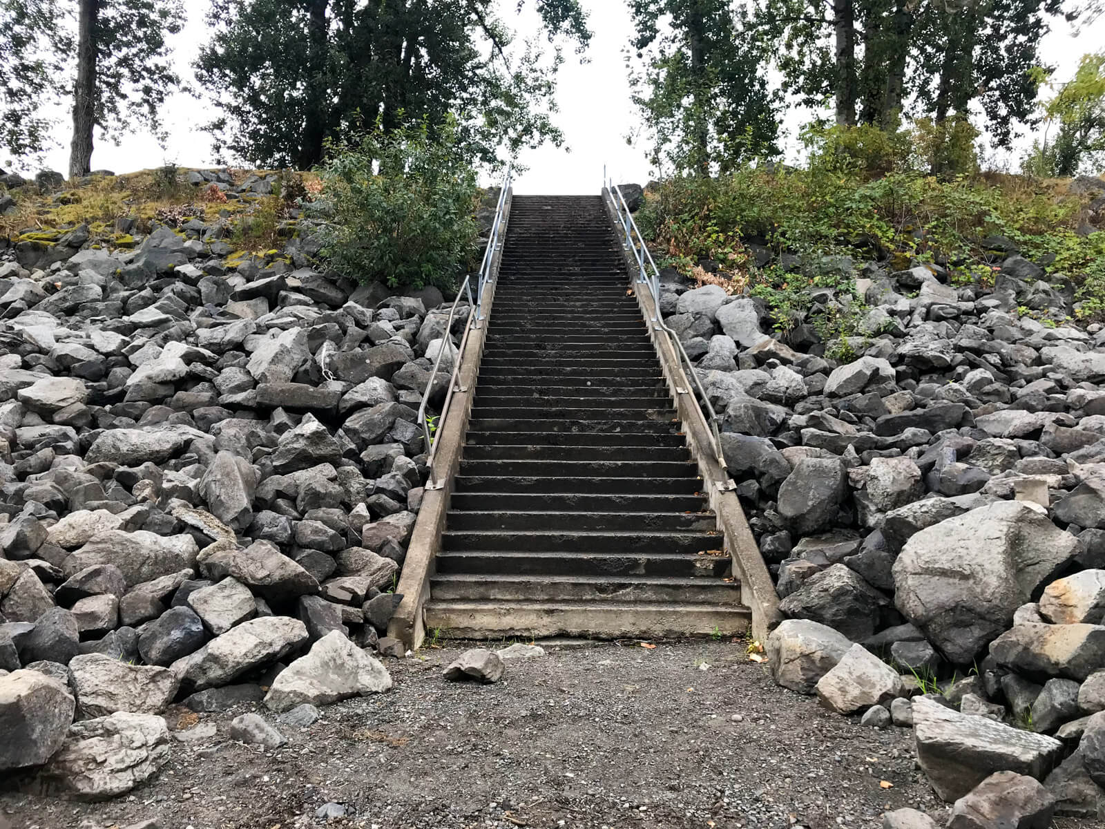 A set of steps going up, with large rocks lining the sides of the steps