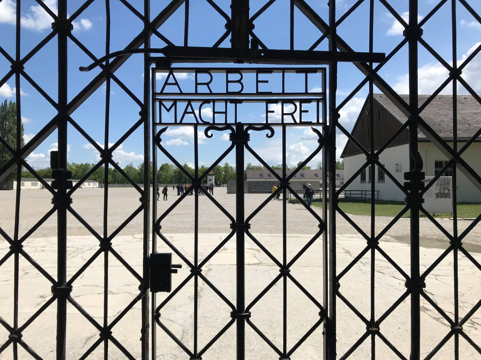 The gate to a concentrattion camp, with metal letters reading “Arbeit macht frei”.