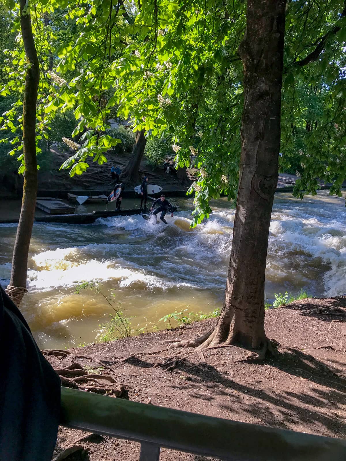 Another section of waterway in the same park, with surfers lining up to surf