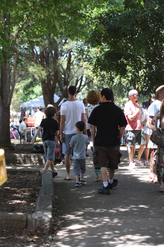 Some people walking down a path in the shade