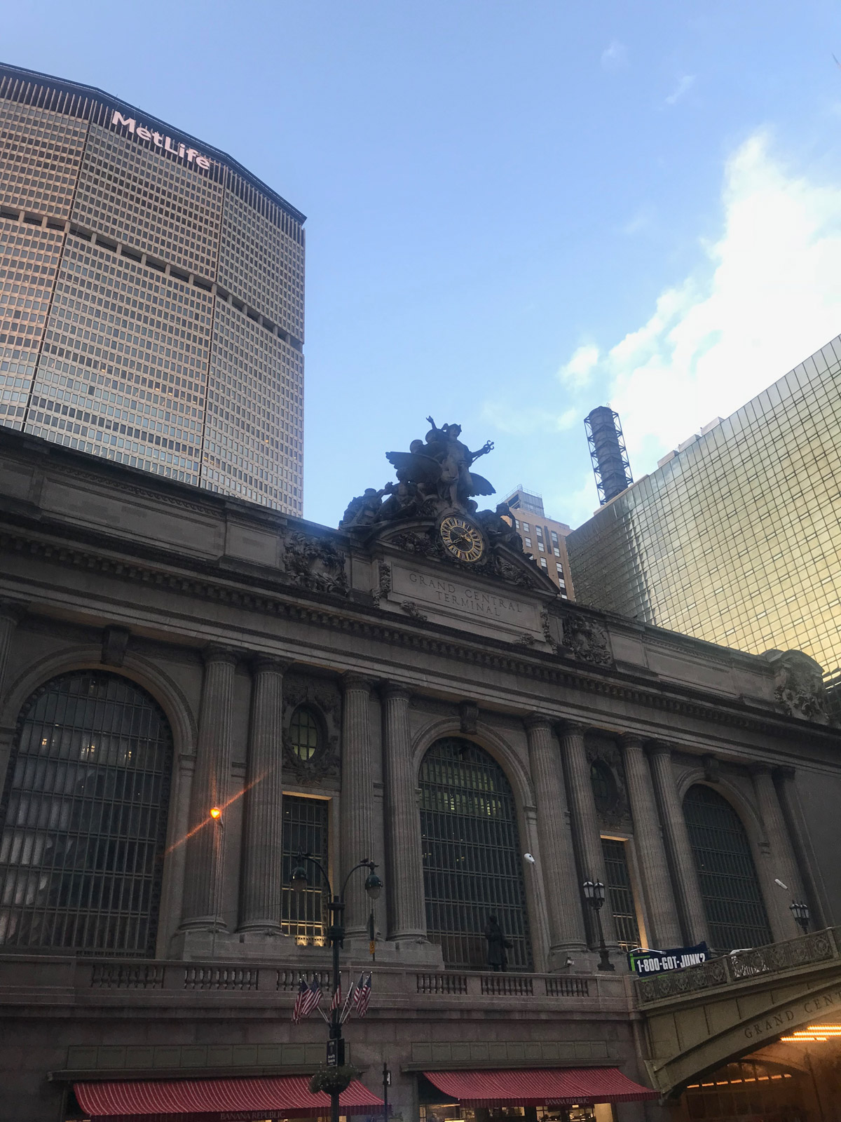 The front of a large train station building with stone architecture