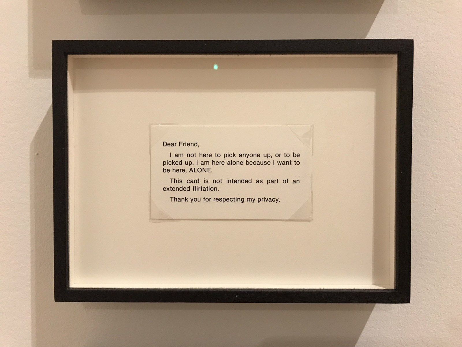 A framed white card reading, in uppercase: “Do not touch, tap, pat, stroke, prod, pinch, poke, grope or grab me.”