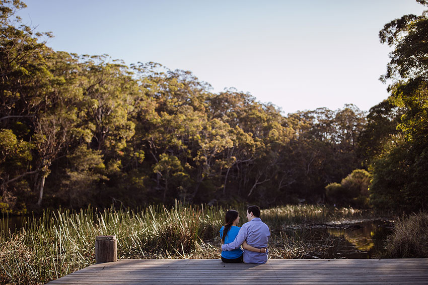 Nick and I sitting on a dock with our arms around each other