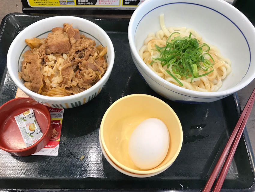 A tray with some chicken don (rice bowl), udon and miso soup