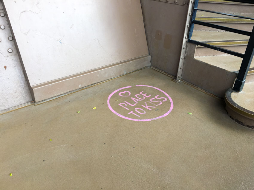 ‘Place to Kiss’ painted on the ground in various spots around the Eiffel Tower