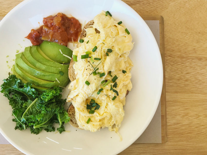 Parmesan scrambled eggs with kale, avocado and tomato relish