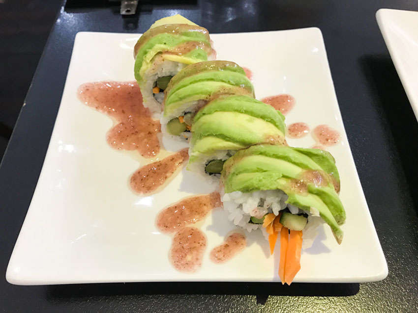 Sushi roll with carrot, cucumber and asparagus and plum sauce