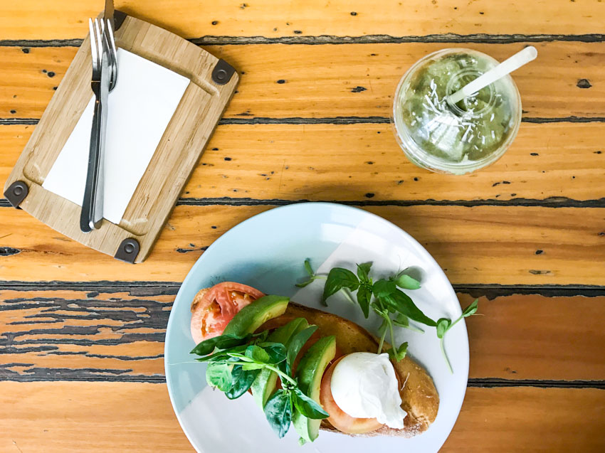 Avocado, tomato, poached egg and feta on toast, with a matcha smoothie