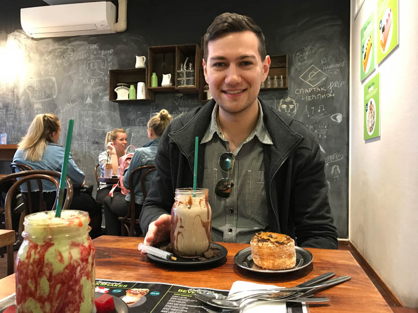 Nick sitting behind a table with our rich desserts on it