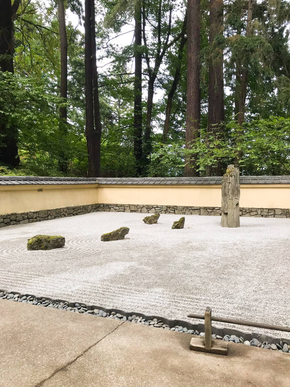 A Japanese zen garden covered with pebbles. Some rocks feature on the pebbles, in a neat formation