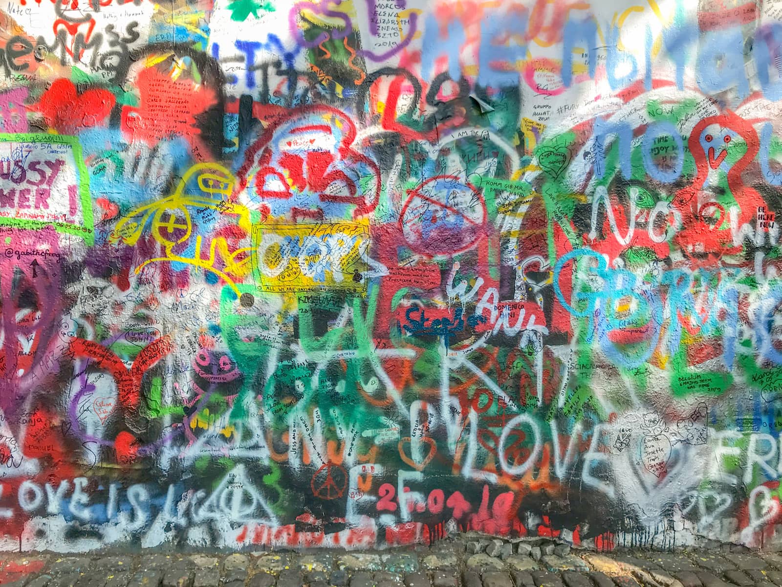 A wall covered in colourful graffiti