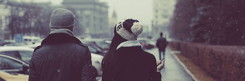 A couple walking together on a snowy day