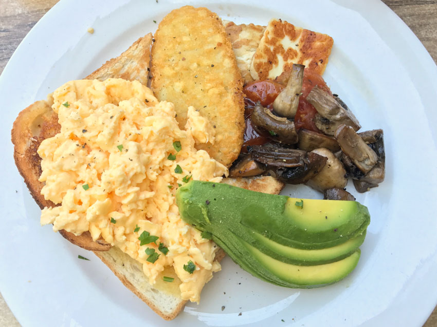 My meal with avocado, hash brown, mushrooms, scrambled eggs, halloumi and tomato relish
