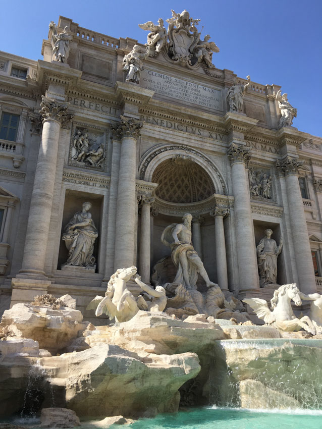 Trevi Fountain during the afternoon, stone figures visible