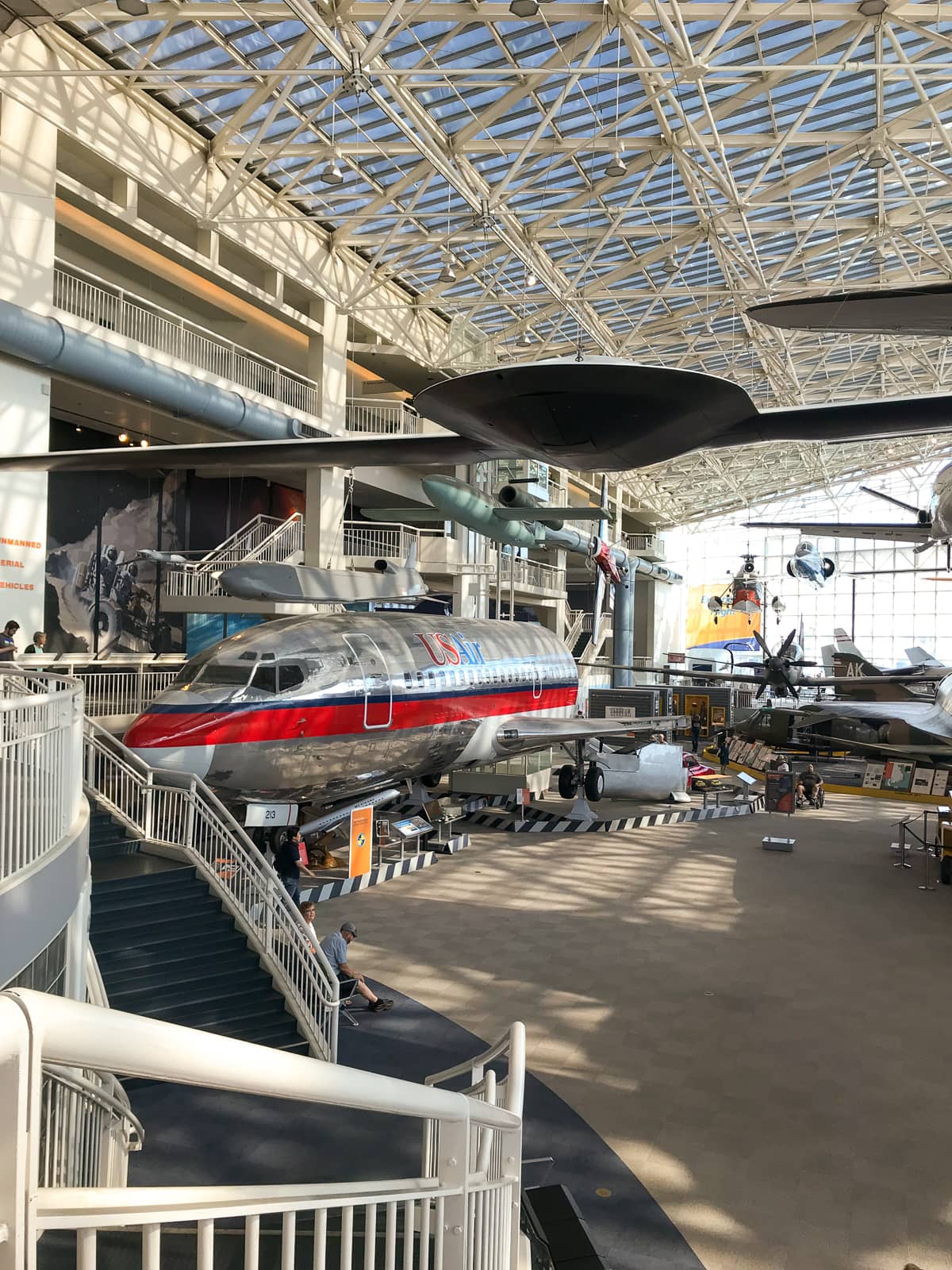 A view of the same room as the previous photo but further to the left side, showing a section of airplane reading “US air”