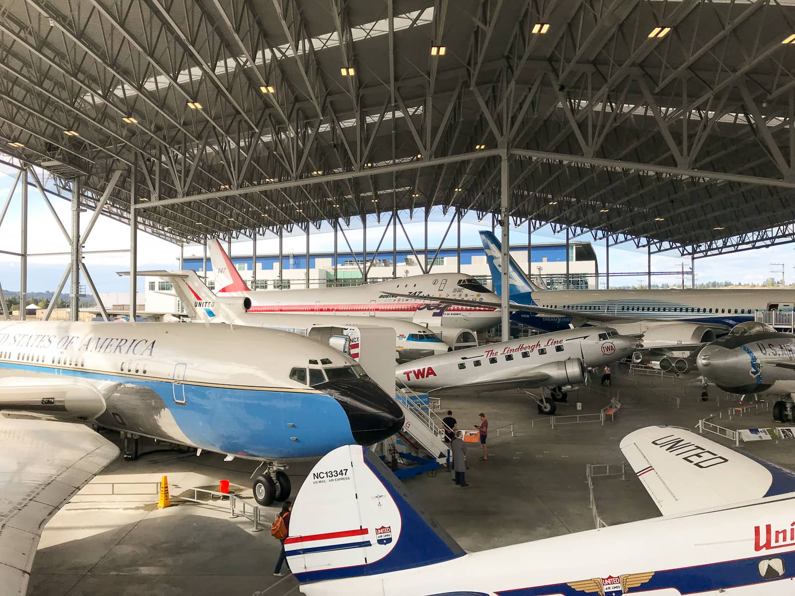 An open covered area with a number of planes, with some stairs available to enter each one