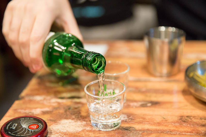 Nick pouring soju into a glass