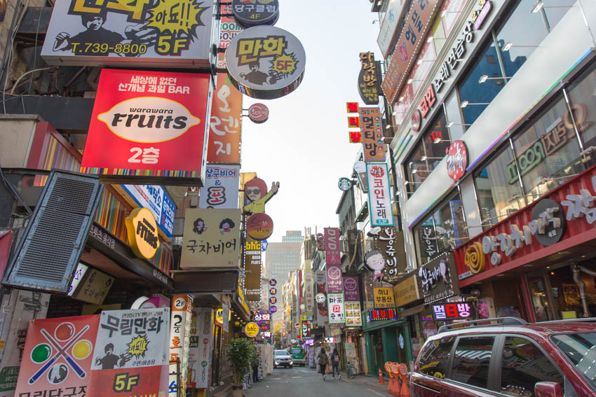 Low angle view of the streets adorned with lots of bright signage