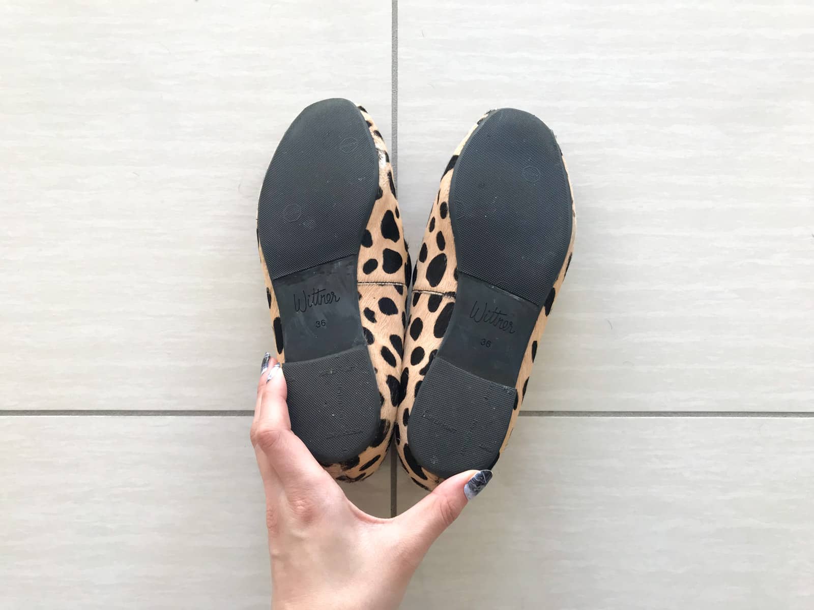 A close-up of the soles of the same pair of recently repaired shoes in the previous photo